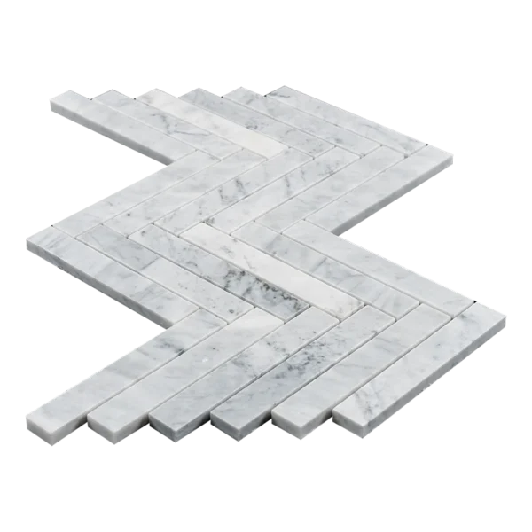 A close-up view of 1x6 honed Carrara marble tiles arranged in a sleek herringbone pattern. The tiles feature a white base with soft gray veining, highlighting their smooth, matte finish and natural texture. Perfect for modern and traditional spaces alike, these tiles add a touch of timeless elegance.