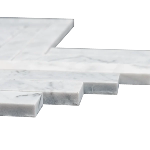 A close-up of the edges of 1x6 honed Carrara marble mosaic tiles arranged in a herringbone pattern. The white marble tiles feature soft gray veining and a smooth, matte finish. The images emphasize the thickness, clean cuts, and natural stone texture, illustrating their high quality and elegant craftsmanship.
