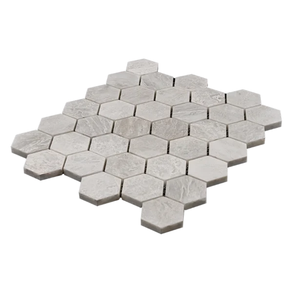 Angled view of 2-inch honed Iceberg marble honeycomb mosaic tile sheet with white and soft gray hexagon pieces for wall applications.