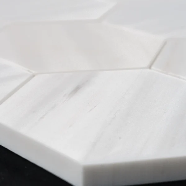 Close-up of 4-inch honed Dolomite marble honeycomb mosaic tile showing soft matte finish and white veining.