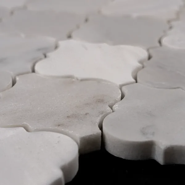 Close-up of Arabesque polished marble mosaic tile in soft white tones showing natural stone texture