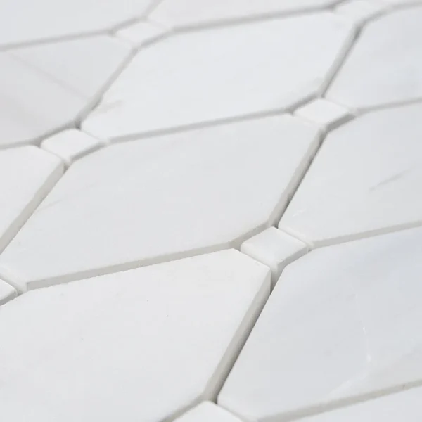 Close-up of white Polished Dolomite mosaic tile in clipped diamond pattern showing smooth surface and sharp edges