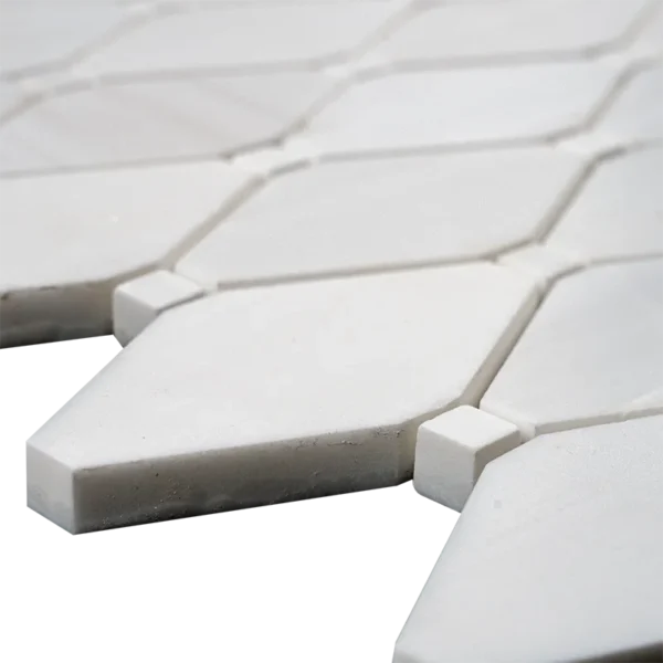 Extreme close-up of clipped diamond polished dolomite mosaic tile showing edge detail and white stone finish
