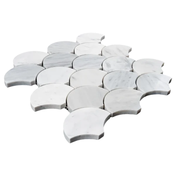 Angled view of Carrara marble fish scale mosaic tiles featuring polished finish and soft white tones with light gray veining