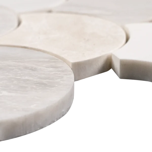Side angle of polished fish scale mosaic tiles in Dolomite, Iceberg with icy veining, and Vanilla marble, showcasing smooth edges and subtle color variation