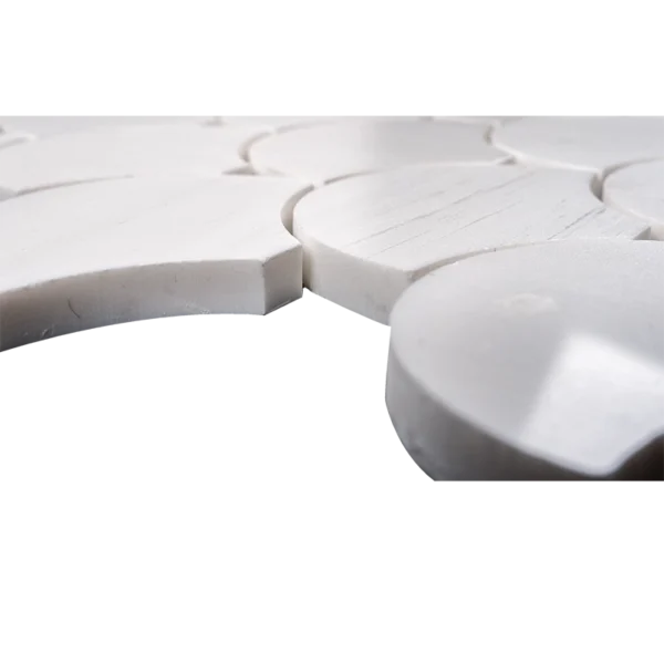 Close-up view of polished Dolomite marble fish scale mosaic tile showing smooth white surface, curved edges, and clean grout spacing.