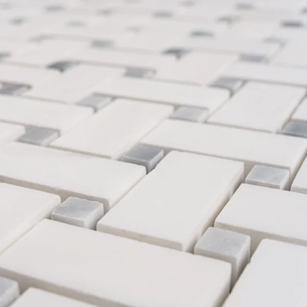 Detailed view of Dolomite basketweave mosaic tile with a combination of white and subtle gray pieces.