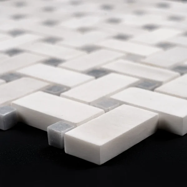 Perspective view of Dolomite honed white and gray basketweave mosaic tile showcasing its geometric pattern.