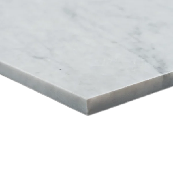 Detailed close-up of the corner and edge of a polished Carrara marble tile, highlighting thickness and clean cut.