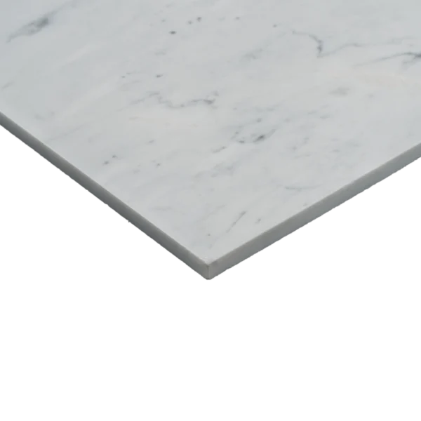Close-up of Carrara marble tile showing polished surface and beveled edge detail