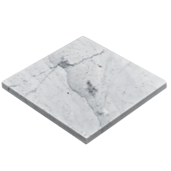Close-up angled view of Carrara 6"x6" honed marble tile showing smooth surface and subtle veining across the grout line.