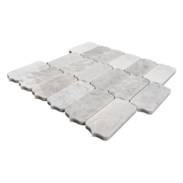 Close-up of a Dorema Dolomite marble mosaic tile sheet in a horizontal arrangement, highlighting the curved edges and natural veining of each rectangular piece.