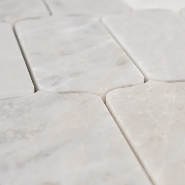 Horizontal layout of Dorema Dolomite marble mosaic tiles with a refined finish, capturing the smooth texture and natural color variation in each rectangular piece.