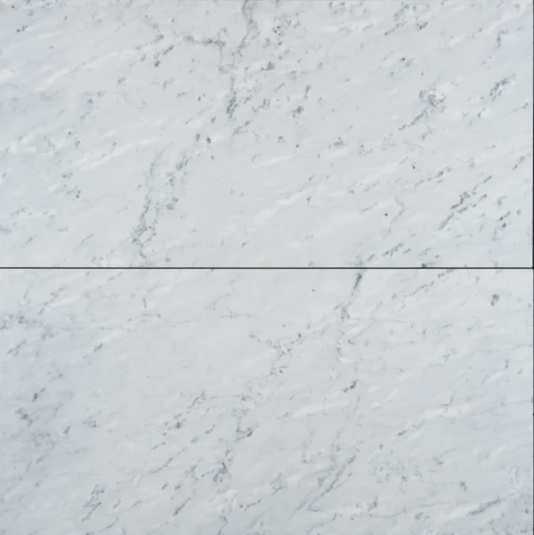 Close-up view of two Eterna Bianco honed marble tiles laid side by side, showcasing natural gray veining.