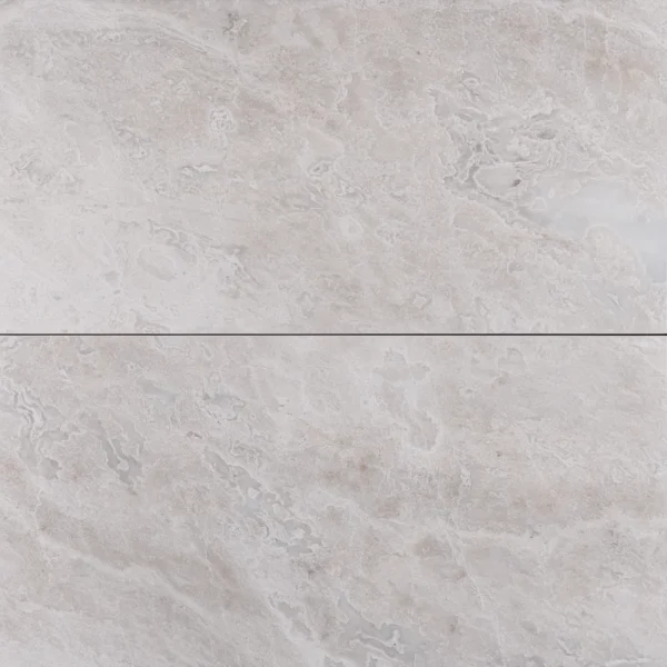 Top-down view of Iceberg marble tile with soft white base and subtle veining, honed finish