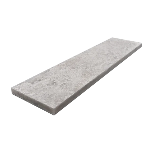 Angled perspective of a 3x12 honed Iceberg marble tile highlighting its thickness and edge detail.