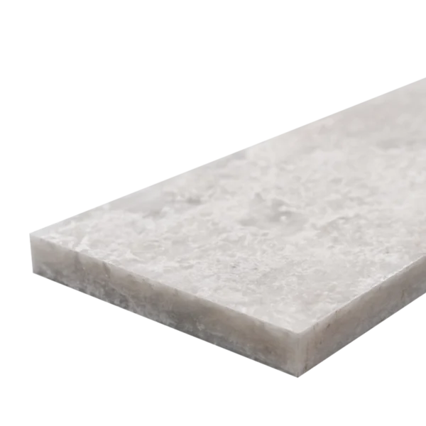 Close-up of a 3x12 honed Iceberg marble tile edge showing fine textural details and clean straight lines.