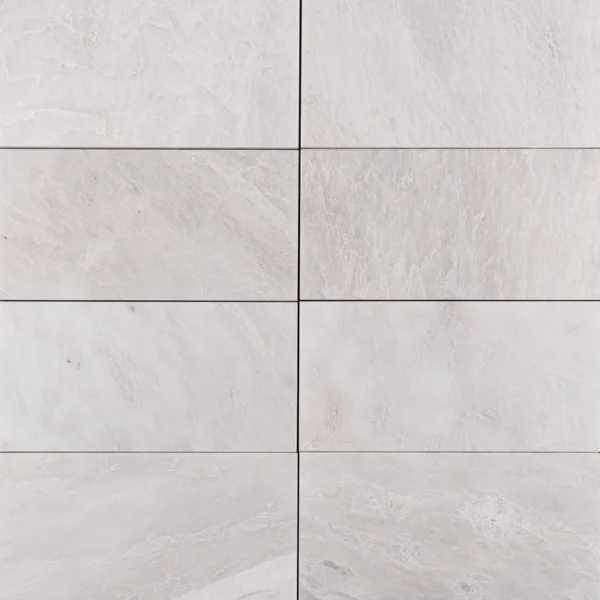 Beveled edge Iceberg marble tile in 6x12 size with a honed finish displayed in grid layout