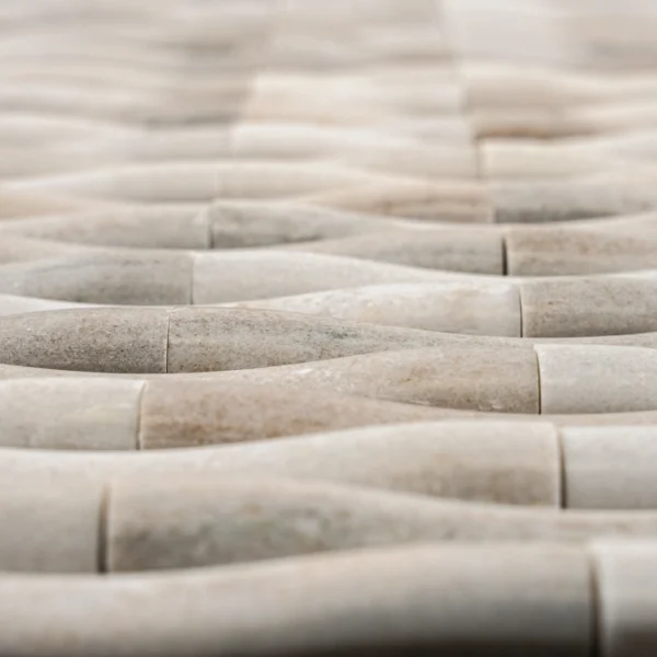 Detailed close-up of the tile ends, illustrating the half-rounded rod profile and natural polish of the Palissandro marble.