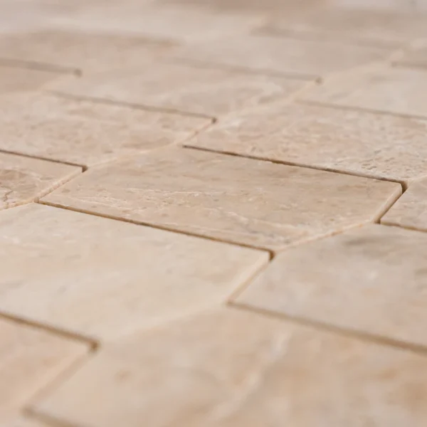 Close-up of Royal Beige Picket marble mosaic showing detailed veining and polished finish