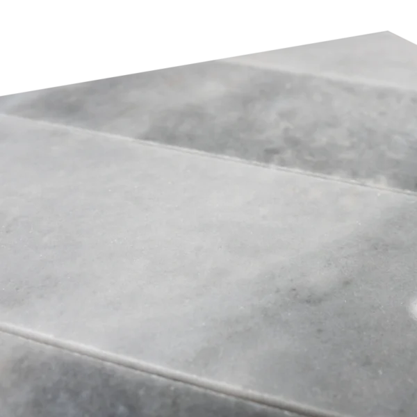 Close-up side view highlighting the thickness and smooth surface of the Piela Bardiglio Polished marble tiles with subtle veining in a grey color palette.