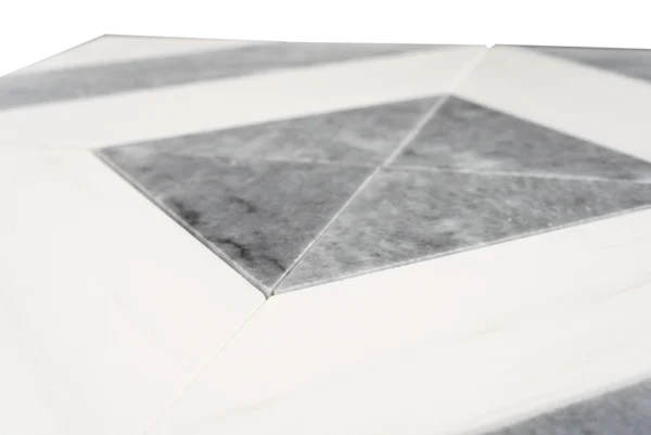 Detailed top-down view of a marble mosaic tile sheet composed of white and gray diamond-shaped tiles, meticulously arranged in a seamless geometric design. The variation in gray veining across the tiles adds movement and sophistication, while the polished finish enhances the luxurious feel.