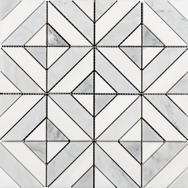A close-up view of a geometric marble mosaic composed of white and gray diamond shapes surrounded by smaller triangular pieces. The precise arrangement highlights the craftsmanship and texture of the natural stone.