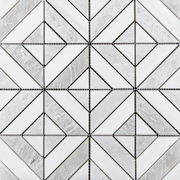 A close-up of a geometric marble mosaic tile in shades of white and gray. The design features intersecting lines forming diamond and triangle shapes, showcasing the natural veining of the stone.