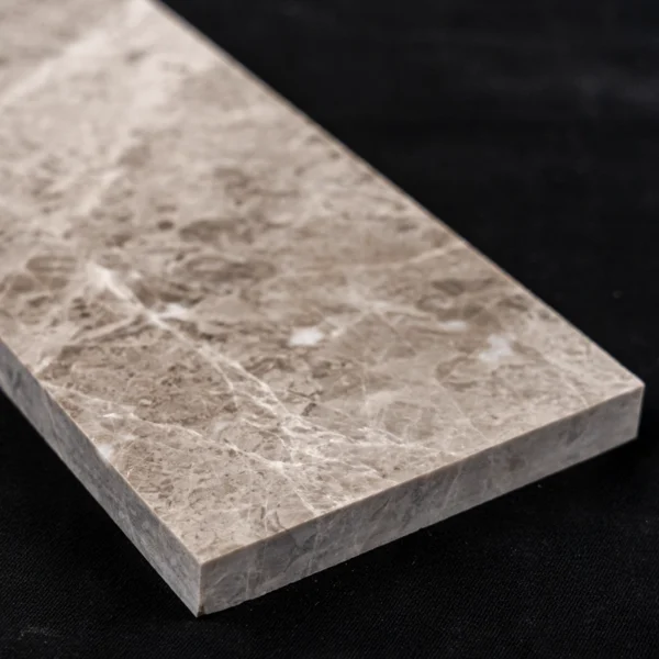 Close-up angled view of a Silver Diamond polished marble tile, emphasizing the tile's thickness and detailed surface texture.