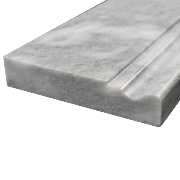 Detailed close-up of Bardiglio polished marble baseboard with contoured top edge