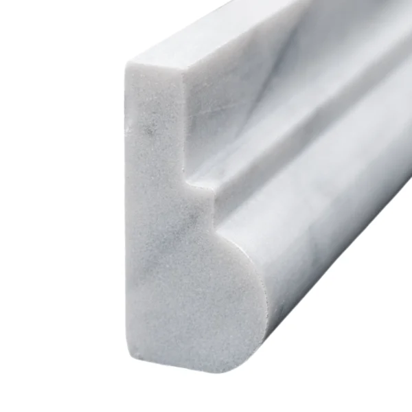 Vertical angle of Carrara marble chair rail showing the edge profile and white base with subtle gray veining.