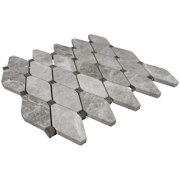 Angled view of polished beige marble diamond mosaic tiles with clipped corners and accent dots.