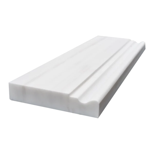Angled perspective of honed Dolomite baseboard trim highlighting edge curvature