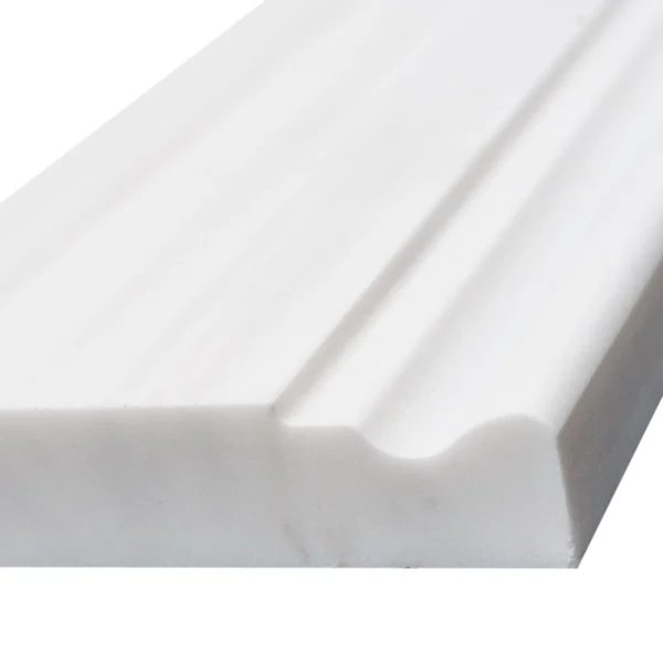 Detailed close-up of Dolomite baseboard edge with smooth matte finish and soft lines
