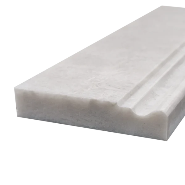Close-up side angle of 4"x12" Iceberg marble baseboard with polished finish and detailed molding edge.