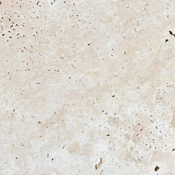Close-up of Ivory 16x24 Tumbled Travertine – Unfilled beige travertine with natural holes and soft tumbled finish