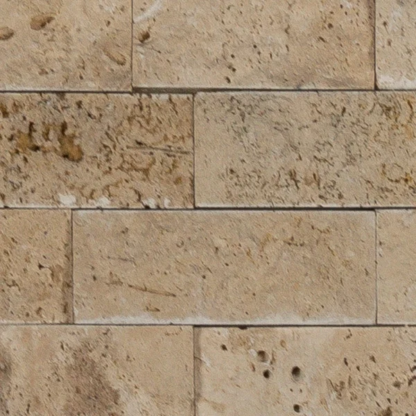 Detail of Ivory travertine splitface tile with classic beige surface and natural pitting