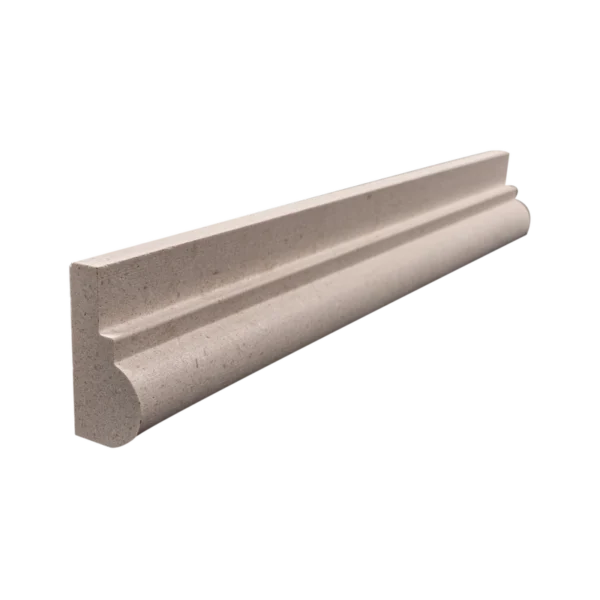Angled side view of honed limestone chair rail trim showing subtle concave profile