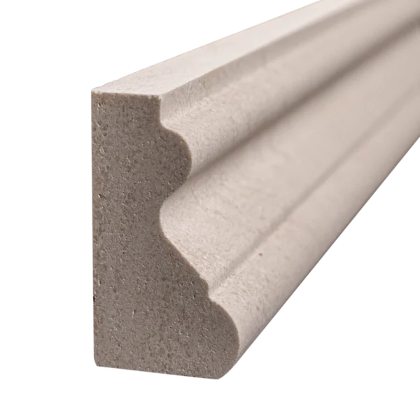 Close-up of honed crown molding in beige limestone with rounded ogee edge and architectural detail.