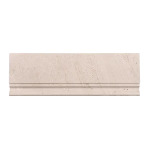 Straight-on image of honed limestone baseboard trim in beige tone with a defined molding edge.