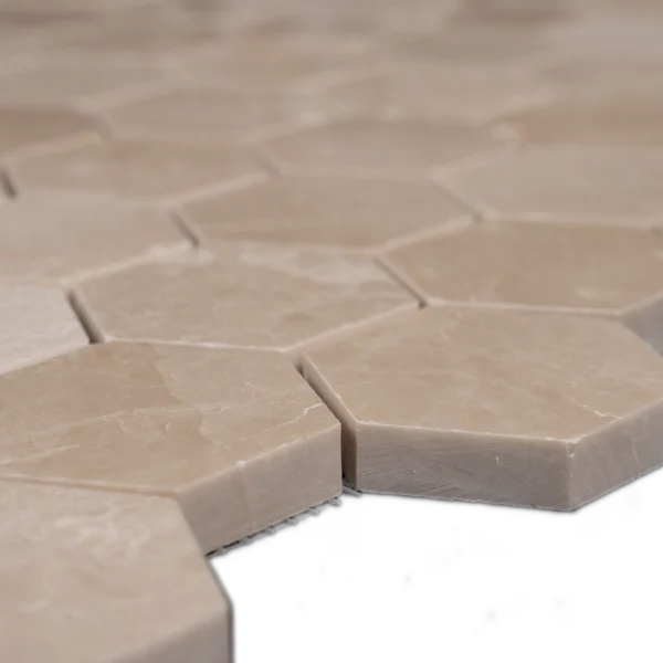 Close-up side view of Botticino 2-inch honeycomb honed marble mosaic tiles showing smooth finish and beveled edges.