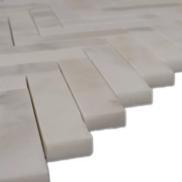 Side perspective of Calacatta 1x4 herringbone honed marble mosaic showing smooth honed surface and veining details.