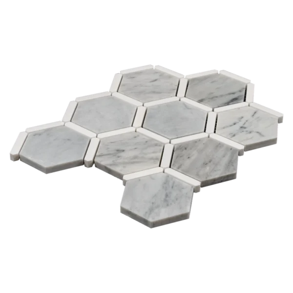 Angled perspective of Carrara marble hexagon mosaic tiles with Dolomite trim, showing depth and polished surface.