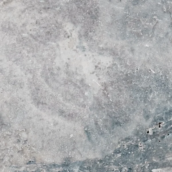 Close-up of Charcoal 12x24 tumbled travertine paver highlighting natural stone patterns and rustic surface for landscaping and pool decks