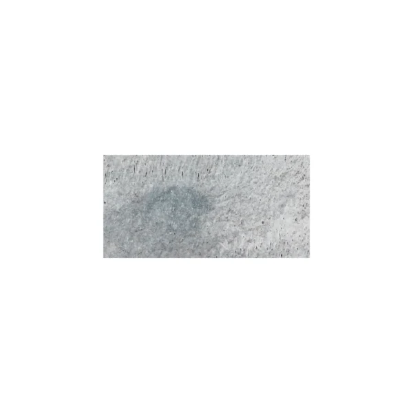 Close-up of Charcoal 6"x12" tumbled travertine paver showcasing its textured surface with natural gray tones and small pits, ideal for rustic outdoor applications.