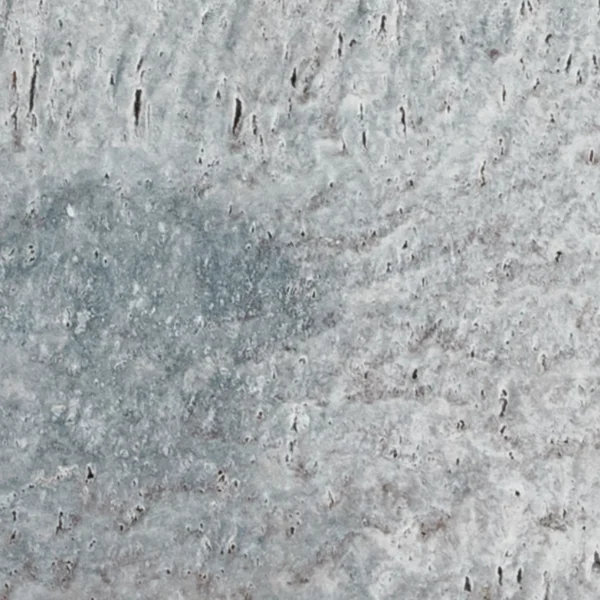 Detailed view of Charcoal 6"x12" tumbled travertine paver with weathered texture, featuring soft variations of gray and natural surface imperfections for an authentic stone look.