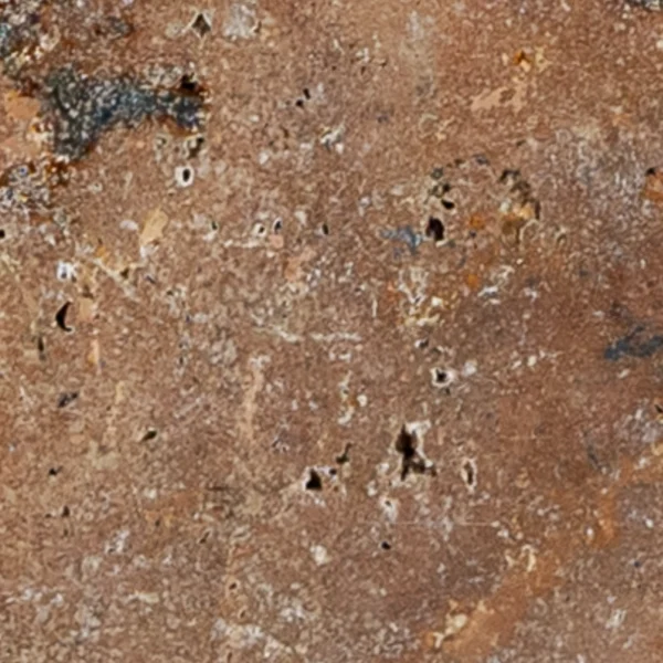 Close-up of Country Classic 6"x12" Tumbled Travertine Paver highlighting its rustic surface details, natural pits, and rich color variations.