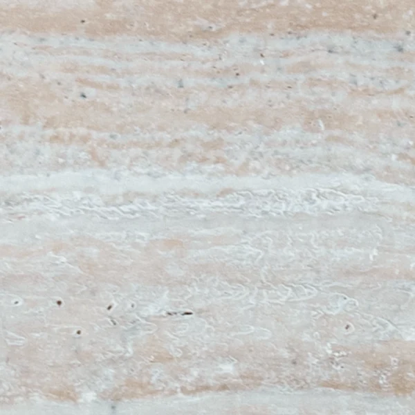 Close-up of Desert Bloom 12x24 tumbled travertine paver highlighting its textured surface, soft beige color variations, and natural stone details.