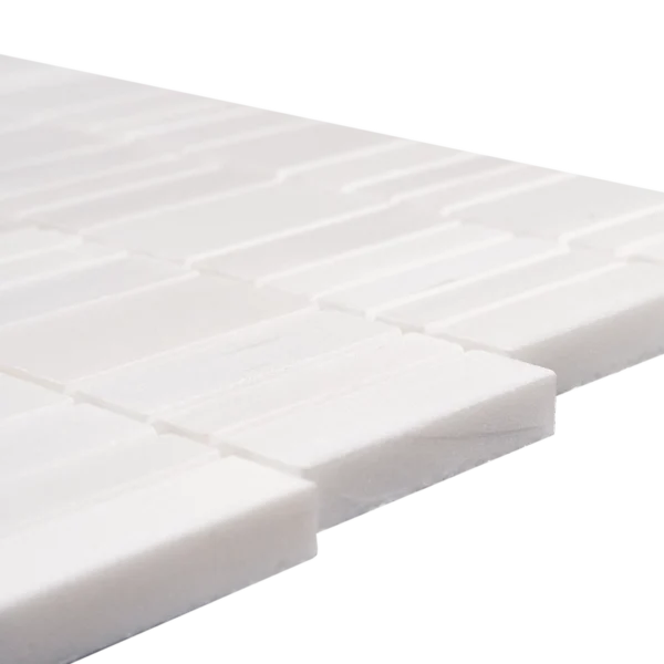 Extreme edge close-up of the polished dolomite strips, emphasizing tile thickness and smooth faces.
