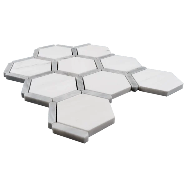 Side perspective of the marble mosaic sheet highlighting the thickness and beveled edges of the polished hexagonal tiles.
